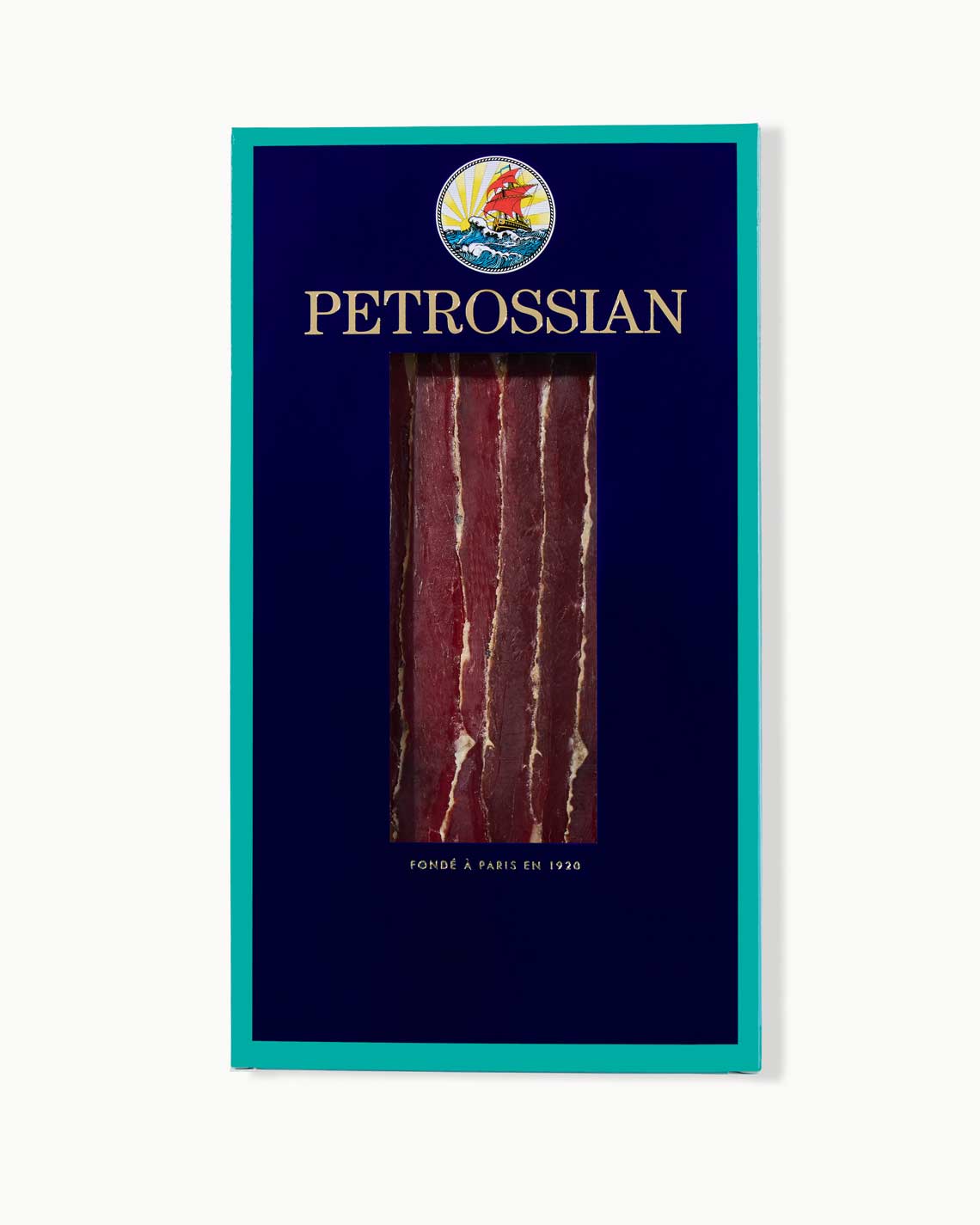 a navy and teal Petrossian box filled with red strips of rich duck prosciutto