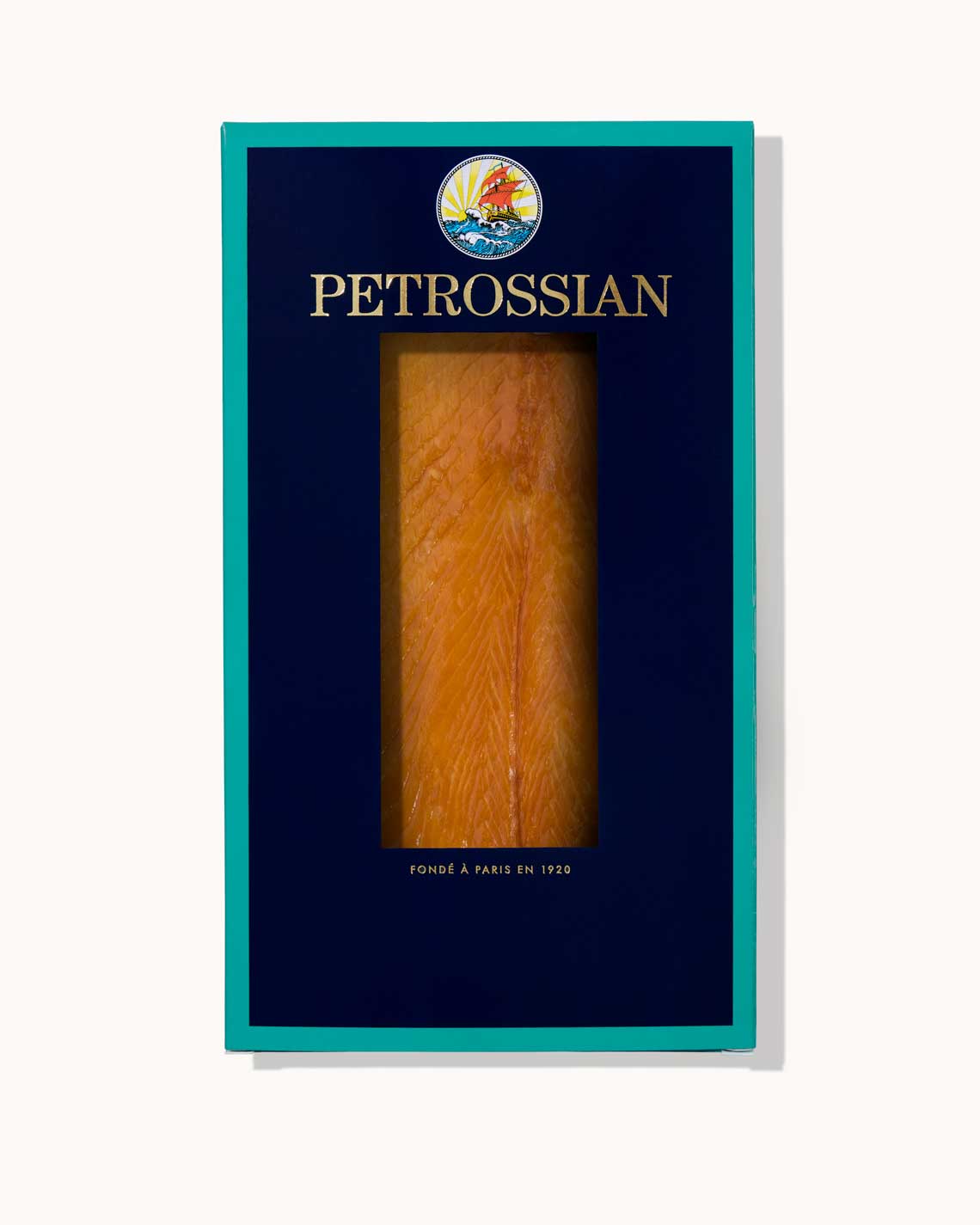 A navy and teal Petrossian box filled with a delicious, orange amber smoked trout