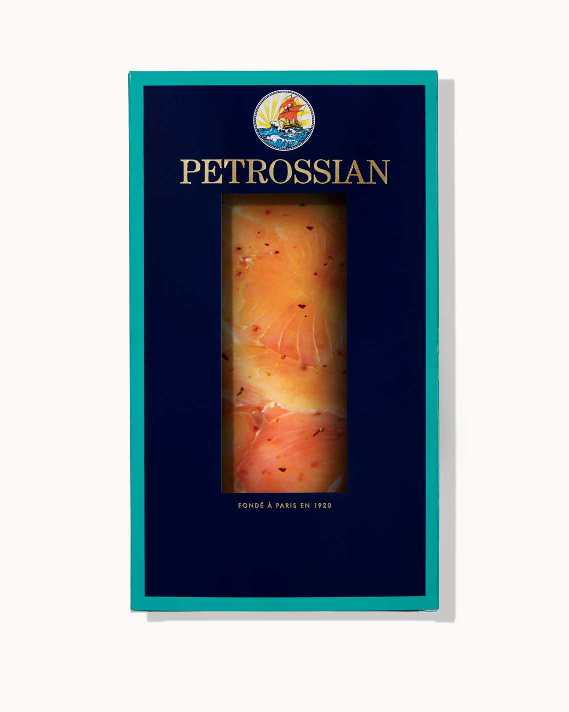 A navy and teal Petrossian box filled with slices of pastrami trout