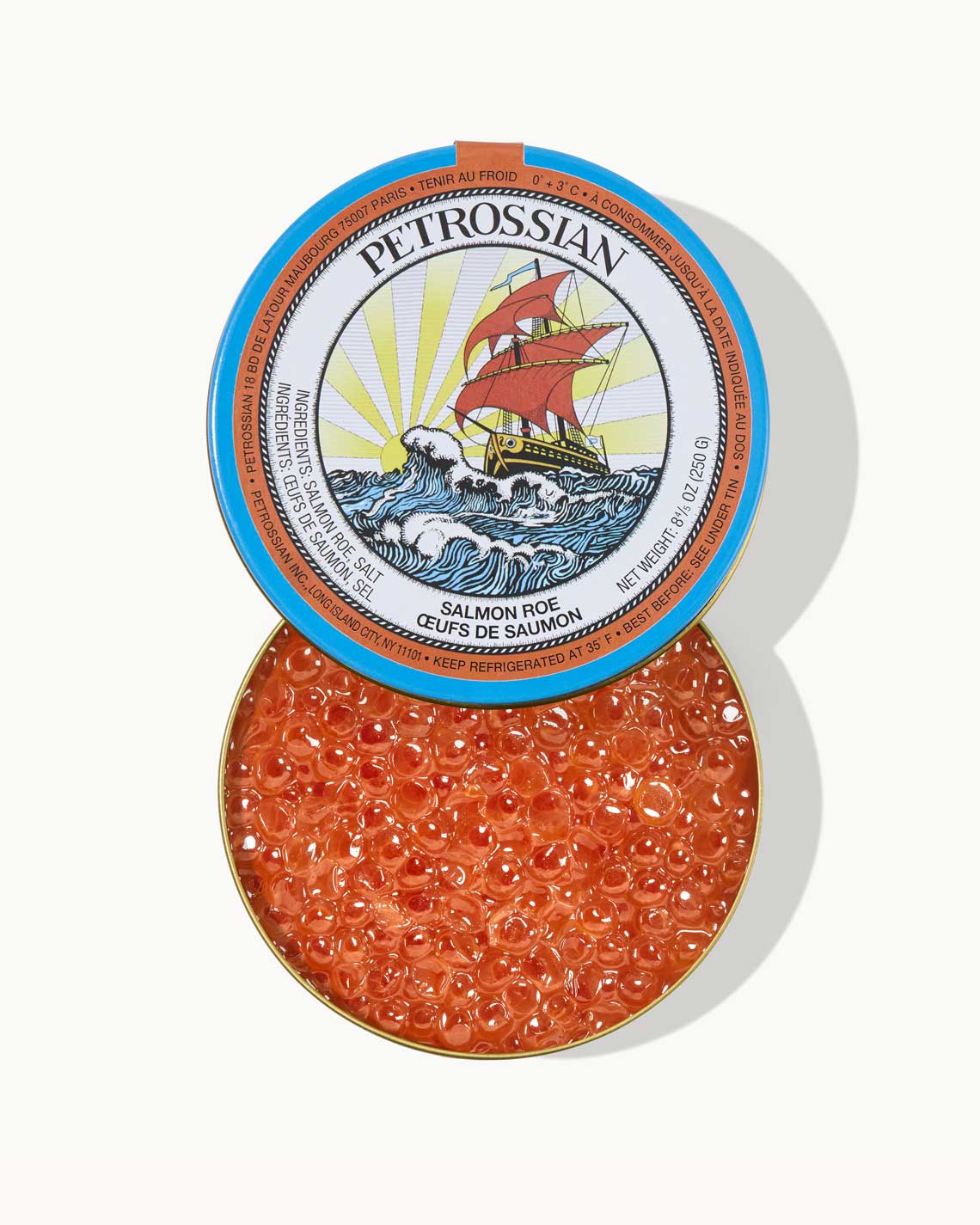 a blue Petrossian tin, opened and filled with bright red, tangy salmon roe