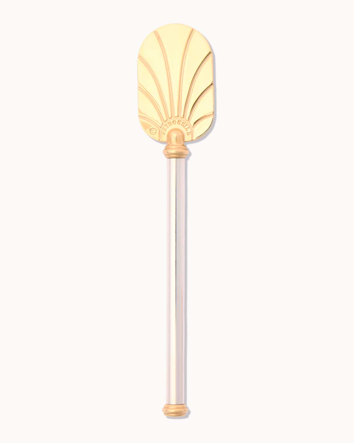 a golden caviar serving palette, with a silver-gilded stem, siting on a white background. It has and ornate design on the the paddle and gold-painted butt end.