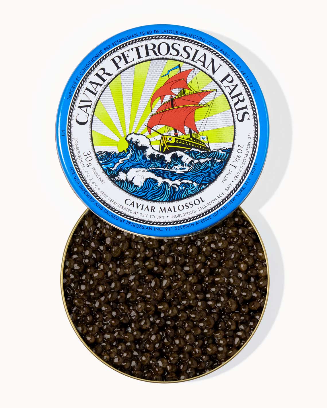 A top down image of an opened blue tin of Petrossian caviar, sitting on a white background. The tin is filled with plump, glistening extra dark green beads of Alverta caviar.