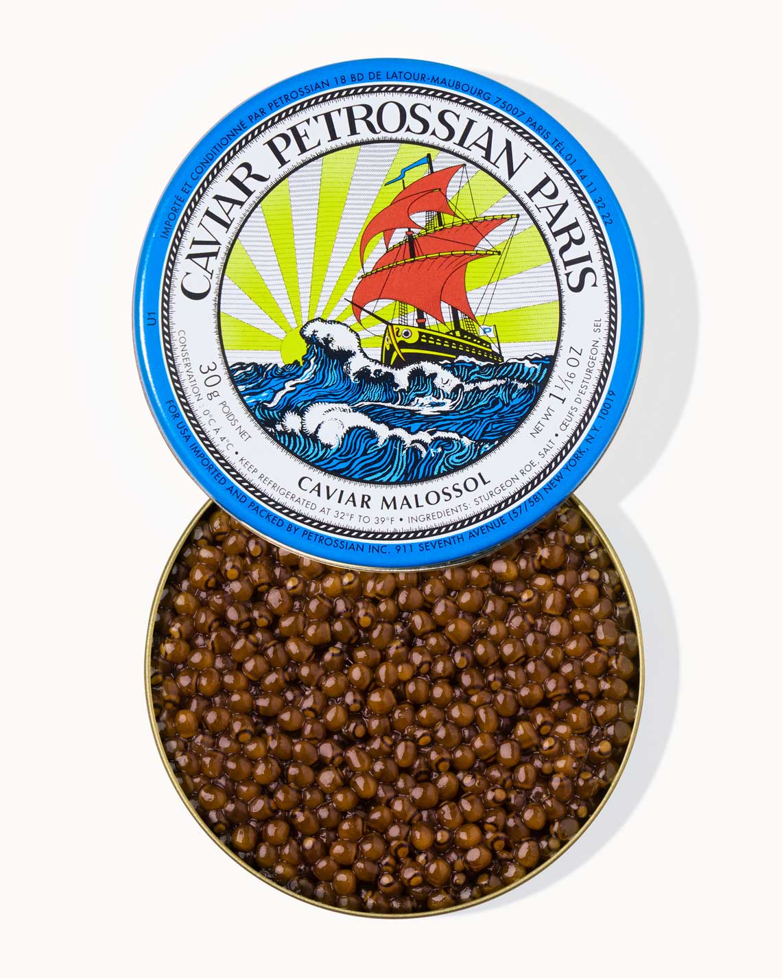 A top down image of an opened blue tin of Petrossian caviar, sitting on a white background. The tin is filled with plump, glistening dark amber beads of Daurenki caviar.
