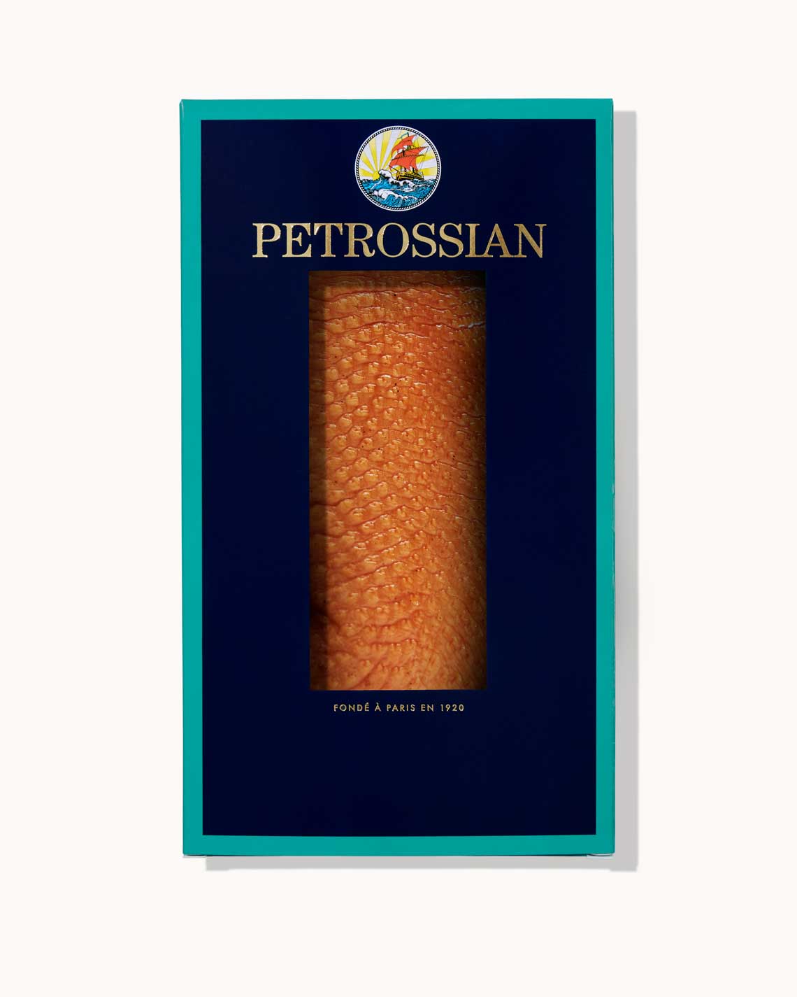 A navy blue Petrossian box with teal trim on a white background. A juicy smoked duck breast can be seen through a cut-out in the center of the box.