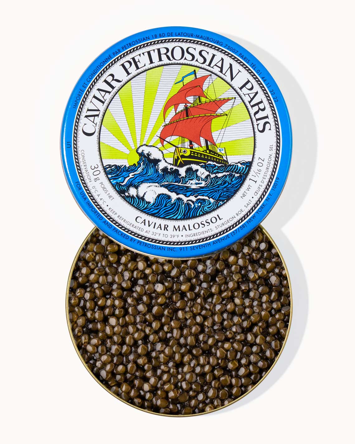 A top down image of an opened blue tin of Petrossian caviar, sitting on a white background. The tin is filled with plump, glistening light green beads of Ossetra caviar.