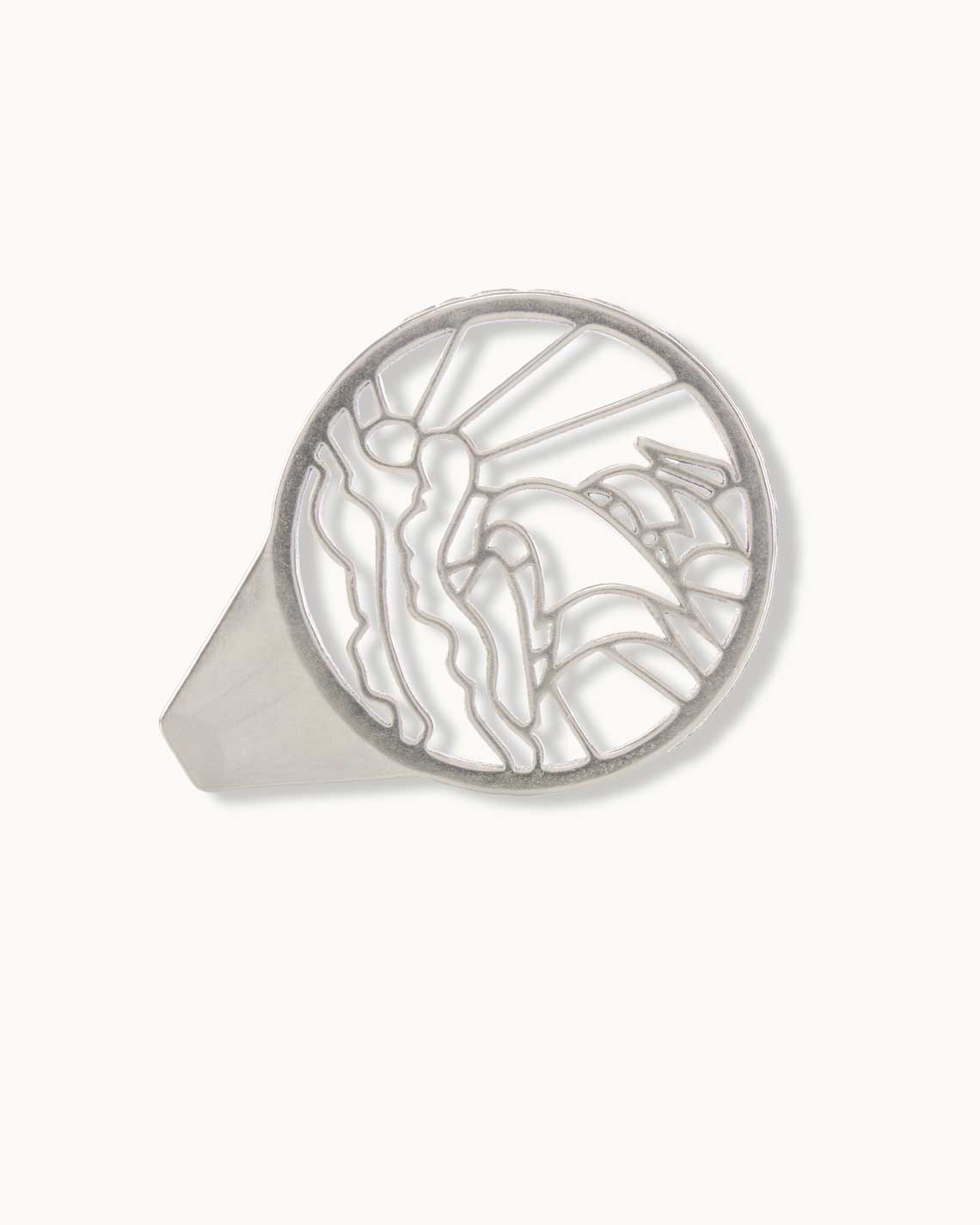 A silver-plated caviar opener, made of thick metal, sits on a white background. It is shaped to show the outline of a sailing ship on the handle.