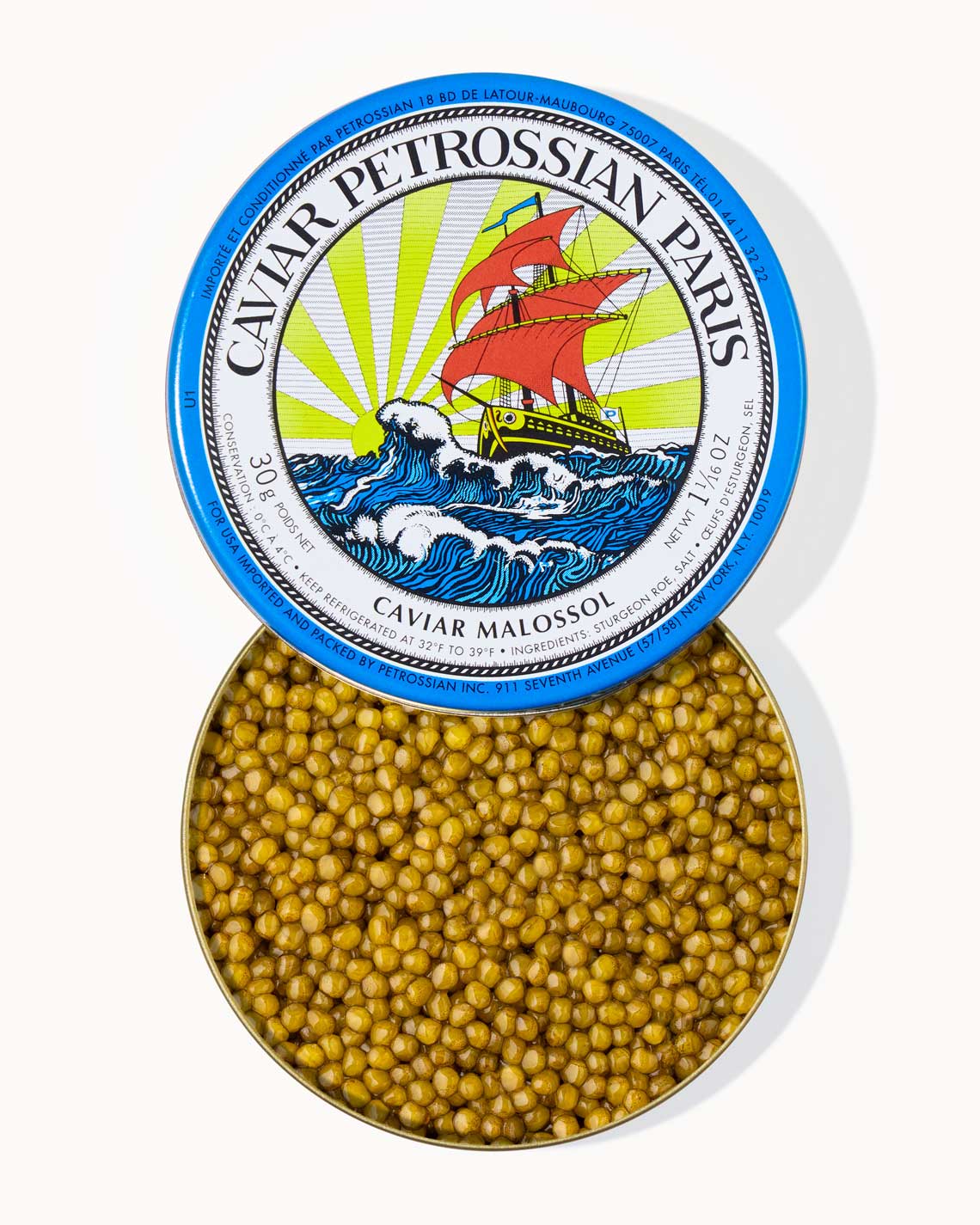 A top down image of an opened blue tin of Petrossian caviar, sitting on a white background. The tin is filled with plump, glistening bright golden beads of Ossetra caviar.