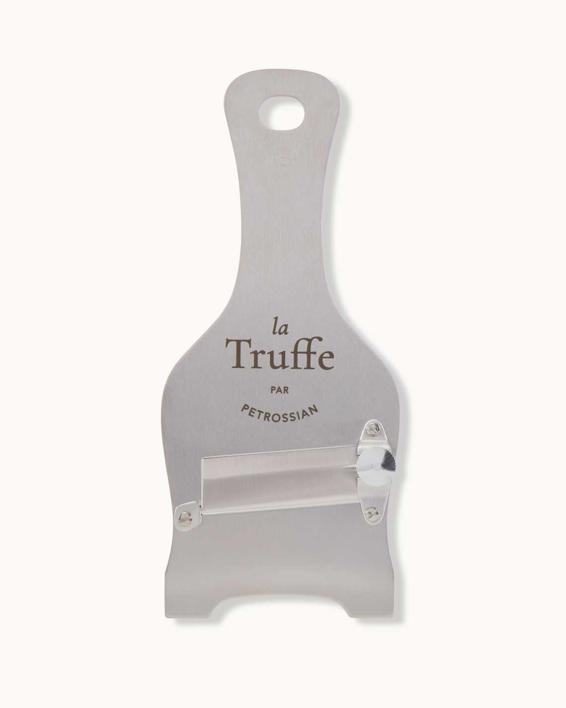 a stainless steel truffle shaver with a Petrossian logo and a metal blade lies on a white background.