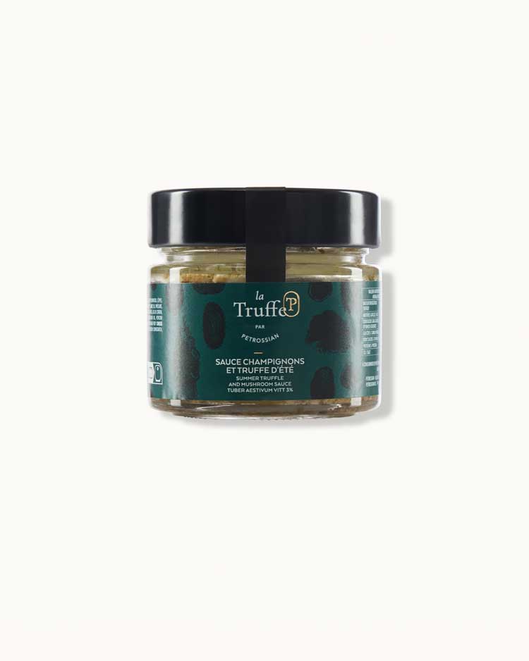 a short glass jar with a dark green "la truffe" label and a black lid sits on a white background. It is filled with a creamy beige mushroom sauce