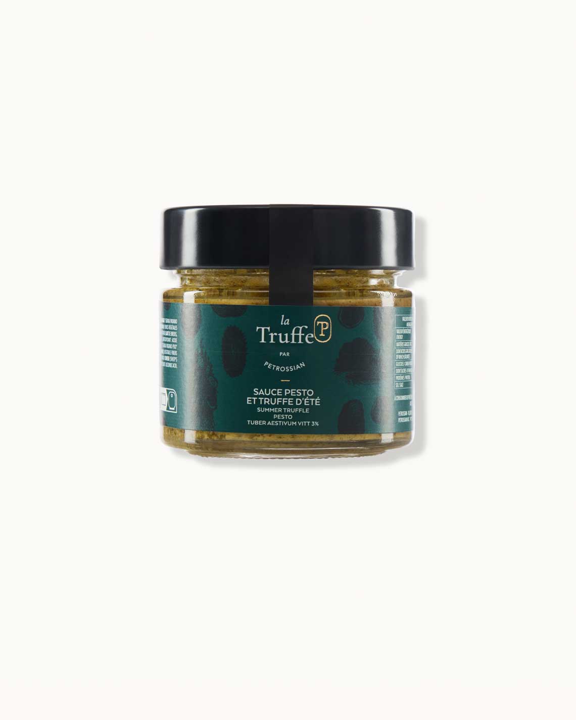 a short glass jar with a dark green "la truffe" label and a black lid sits on a white background. It is filled with vibrant green pesto sauce.