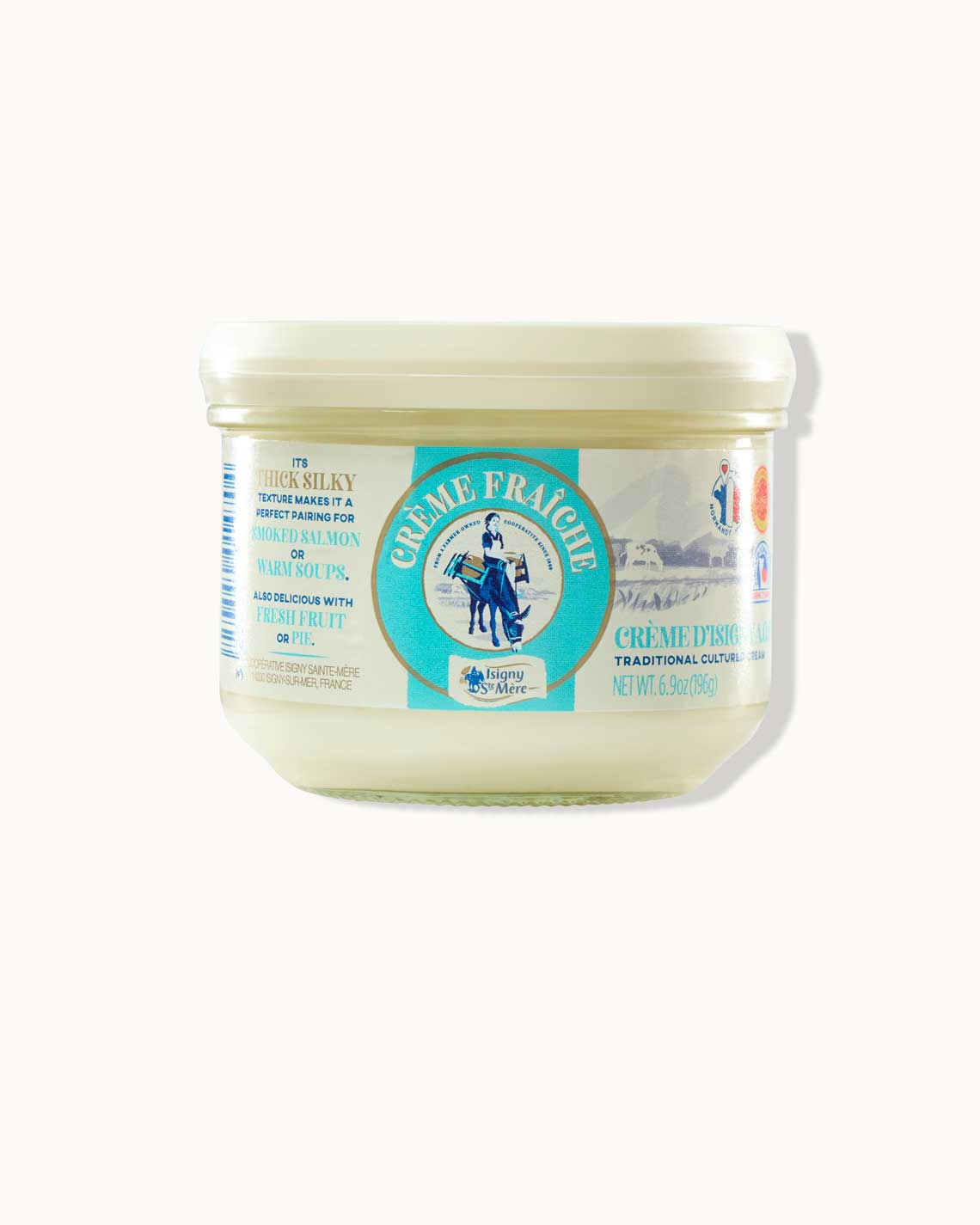 A white jar of creme fraiche with a colorful label