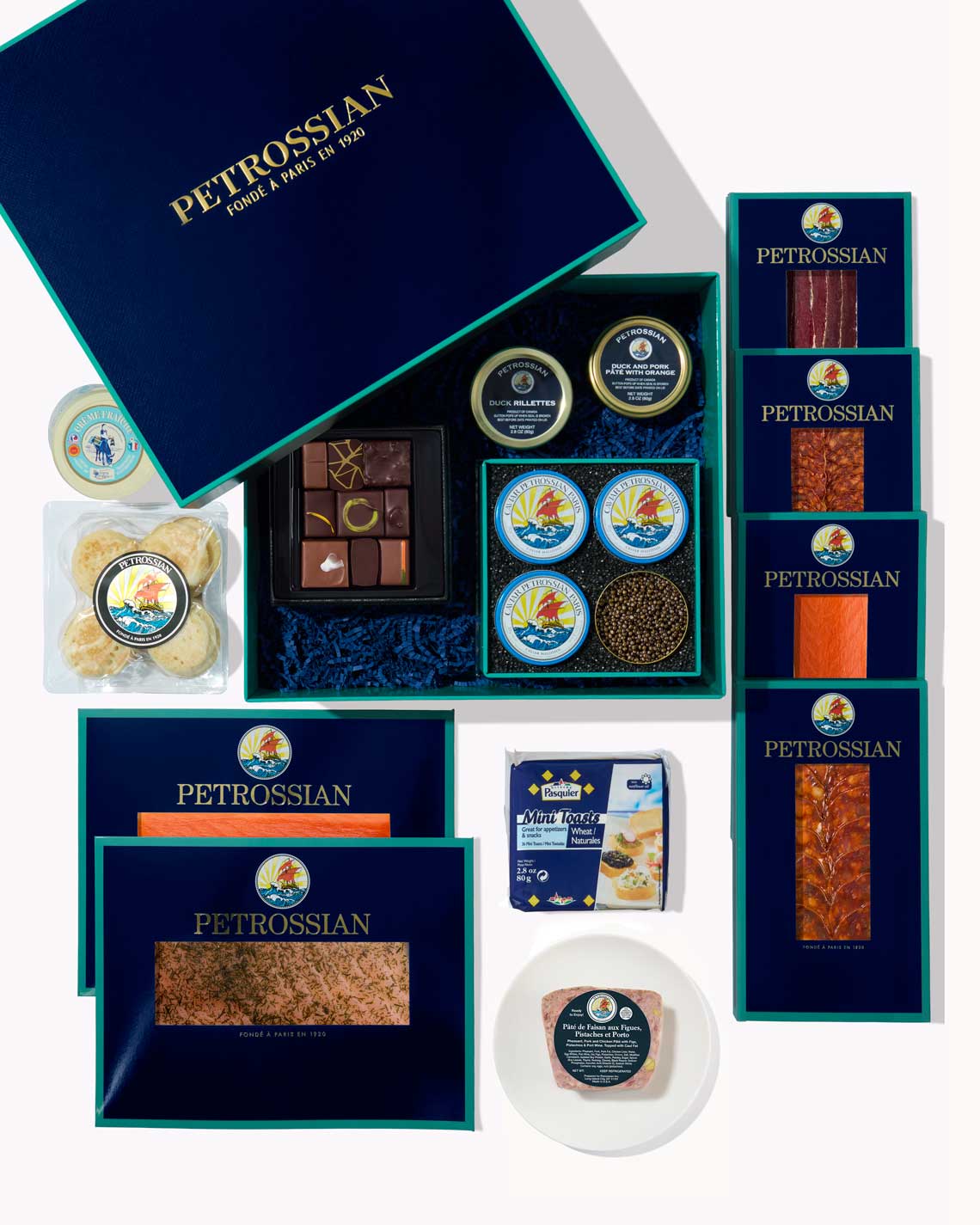 a top-down image of a Petrossian gift box with the contents of the basket laid out on a white background