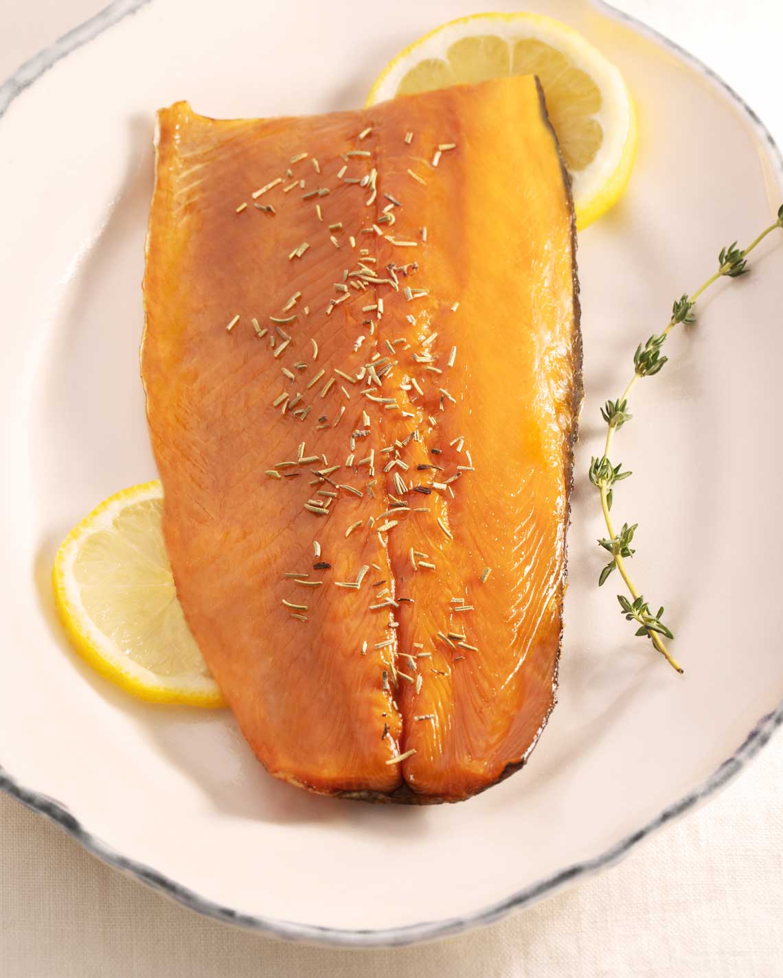 a beautiful smoked trout filet, plated with lemon and herbs